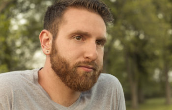 bearded-young-man with gauged ears and stylish haircut